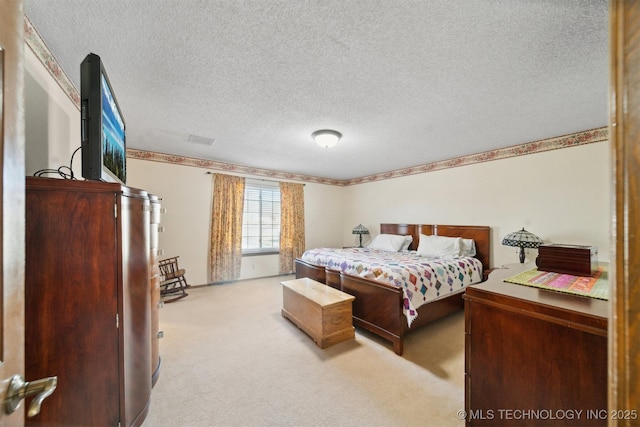 carpeted bedroom featuring a textured ceiling