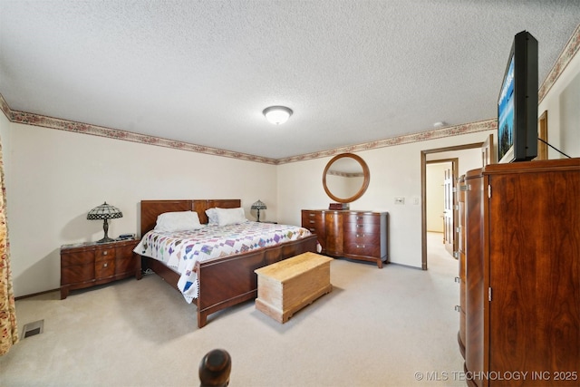 carpeted bedroom with a textured ceiling