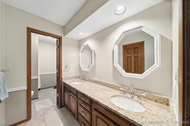 bathroom featuring tile patterned flooring, vanity, and toilet