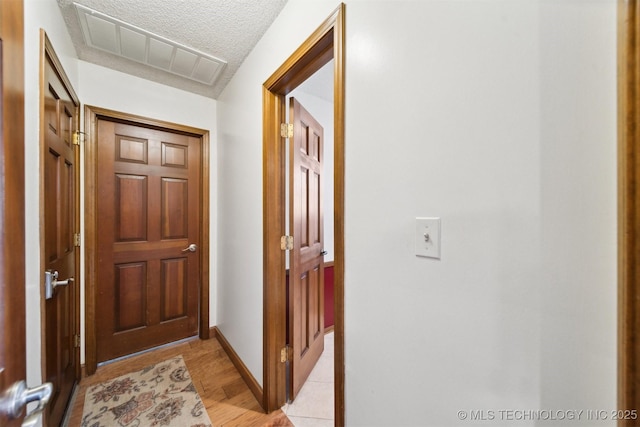 hallway featuring a textured ceiling