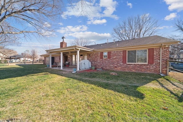 back of house with a yard and a patio area