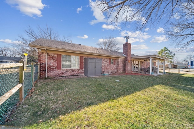 back of house with a yard and a patio