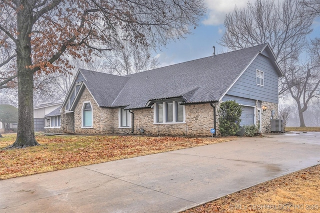 view of front of house featuring central AC unit and a garage