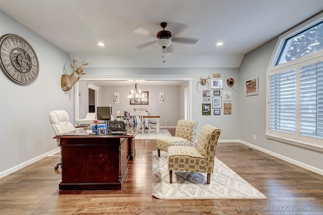 living room featuring wood-type flooring, ceiling fan with notable chandelier, and vaulted ceiling