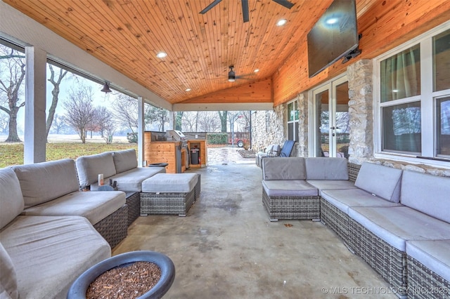 sunroom with ceiling fan, wood ceiling, and lofted ceiling