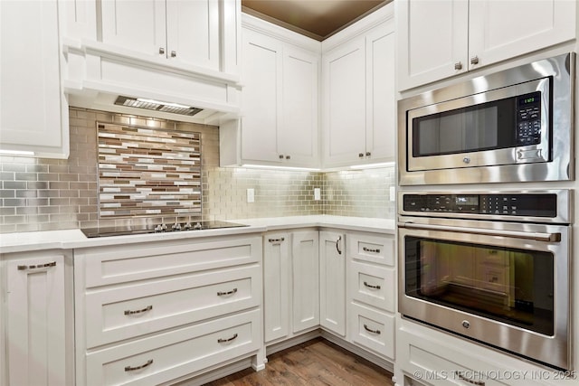 1109 W 84th Pl S, Tulsa, OK 74132 - kitchen with stainless steel appliances, custom range hood, light countertops, and white cabinets