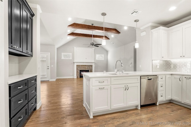 kitchen with ceiling fan, dishwasher, vaulted ceiling with beams, hanging light fixtures, and white cabinets