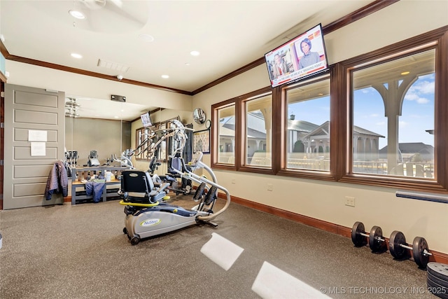 exercise area featuring ceiling fan and ornamental molding