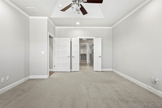 1109 W 84th Pl S, Tulsa, OK 74132 - unfurnished bedroom featuring light carpet, baseboards, crown molding, a walk in closet, and a ceiling fan
