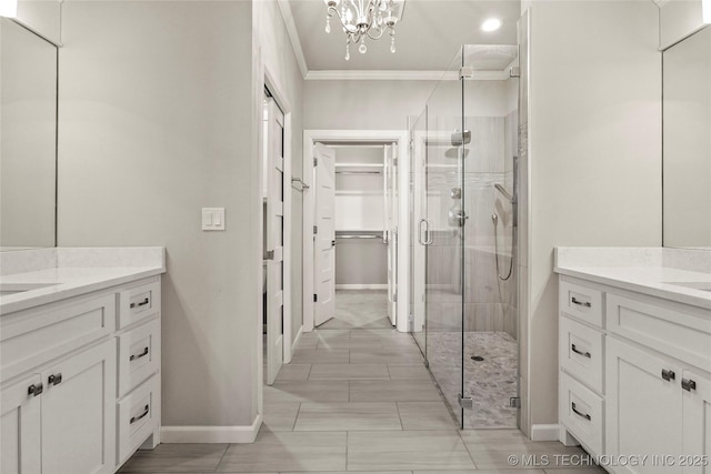 bathroom featuring walk in shower, vanity, an inviting chandelier, and crown molding