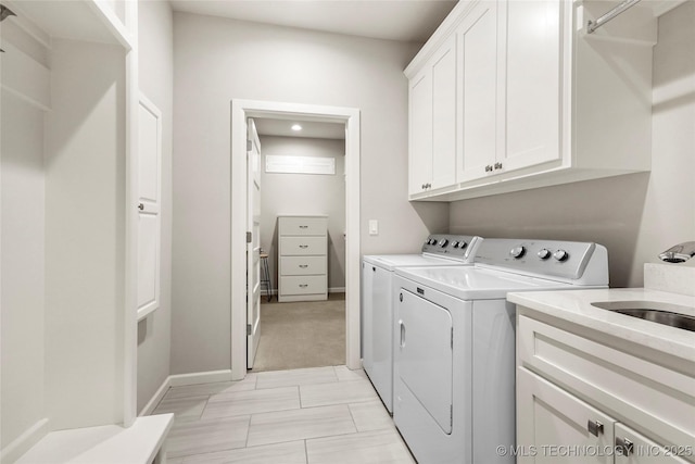 laundry room with cabinets and washer and dryer