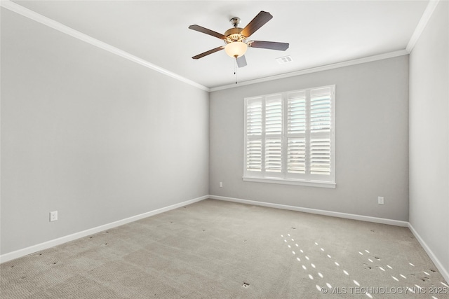 empty room featuring light carpet, ceiling fan, and crown molding