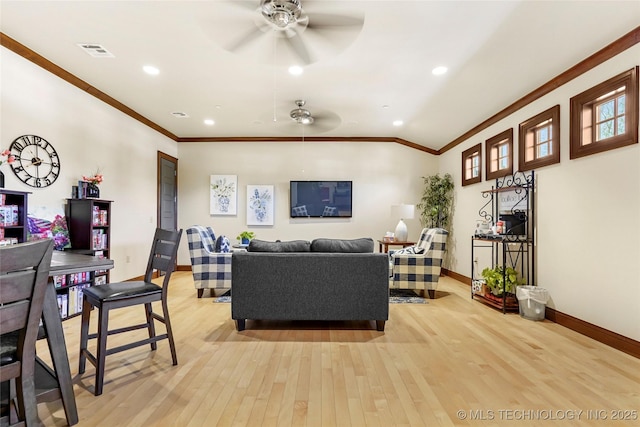 living room featuring ceiling fan, light hardwood / wood-style flooring, and ornamental molding