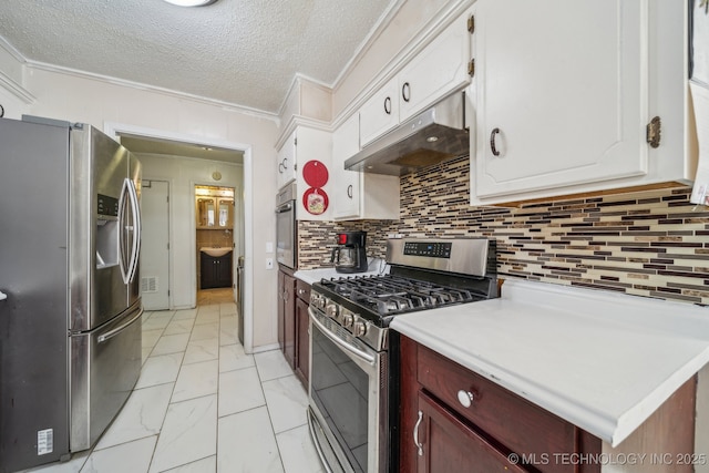 kitchen featuring a textured ceiling, stainless steel appliances, crown molding, and backsplash