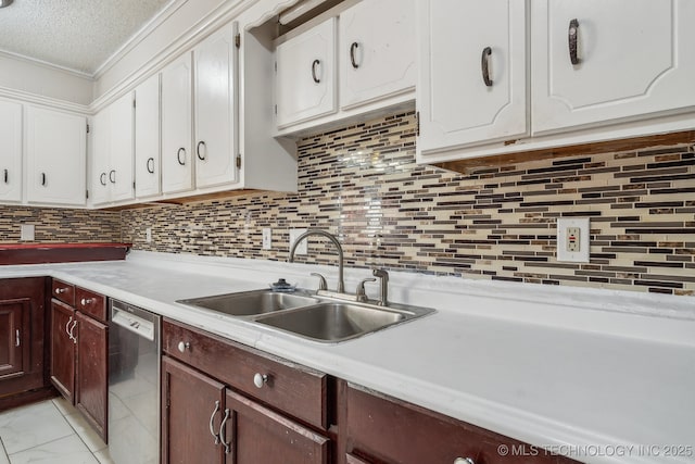 kitchen with decorative backsplash, white cabinetry, dishwasher, and sink