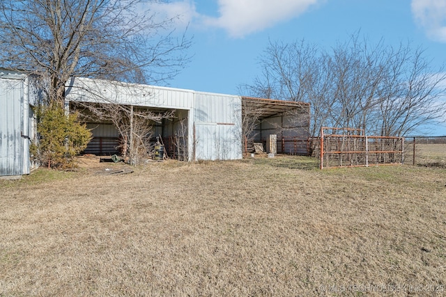 view of outbuilding featuring a lawn