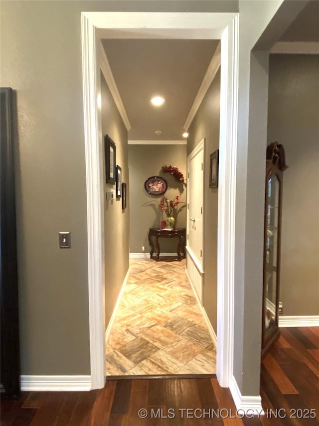 hallway featuring hardwood / wood-style flooring and ornamental molding