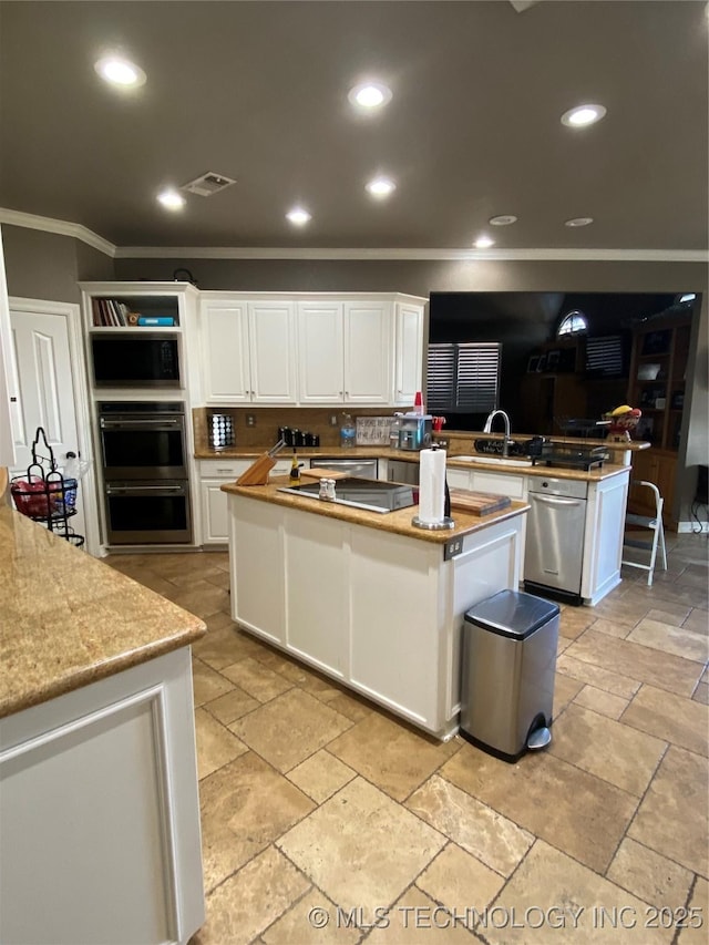 kitchen featuring kitchen peninsula, sink, black appliances, white cabinets, and a center island