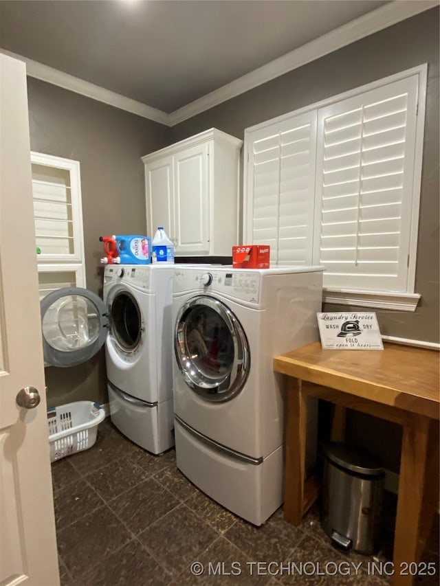 laundry room featuring independent washer and dryer, cabinets, and ornamental molding