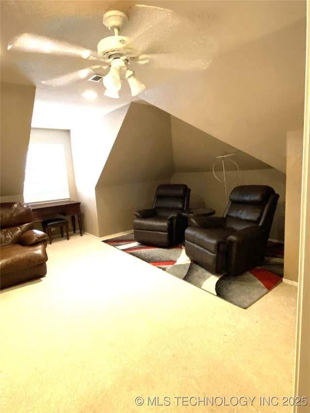 interior space featuring ceiling fan and carpet