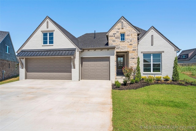 view of front of property with a garage and a front yard