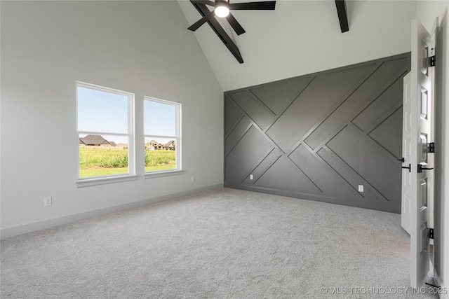 unfurnished room featuring ceiling fan, beam ceiling, light colored carpet, and high vaulted ceiling