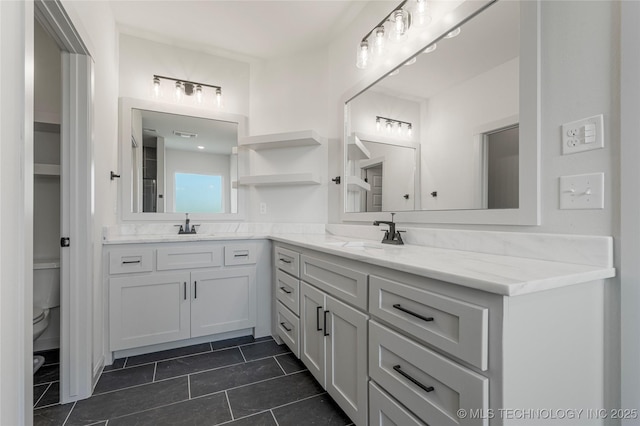 bathroom with tile patterned floors, vanity, and toilet