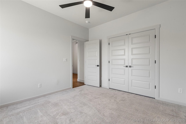 unfurnished bedroom with light carpet, a closet, and ceiling fan