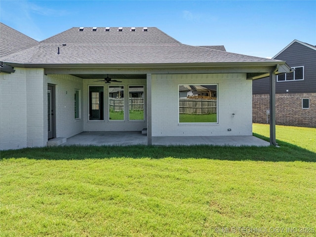 rear view of house with a yard, ceiling fan, and a patio area