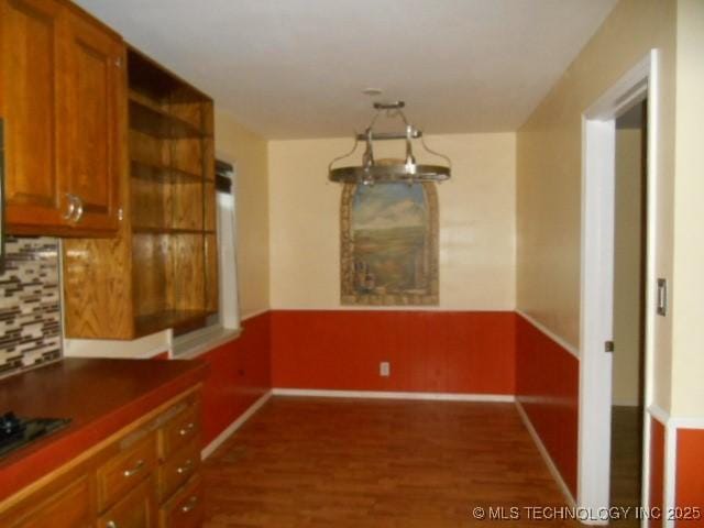 unfurnished dining area featuring dark hardwood / wood-style floors