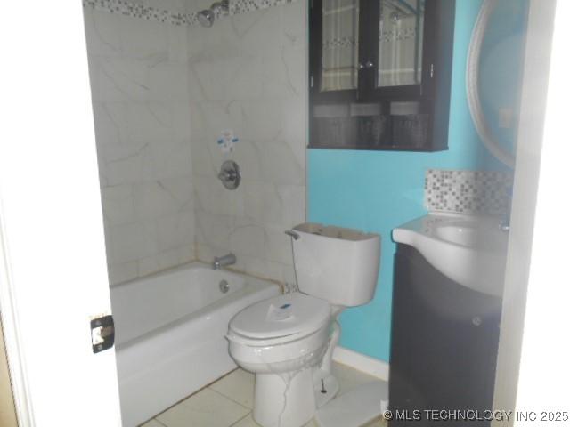 bathroom featuring tile patterned flooring, shower / bathtub combination, and toilet