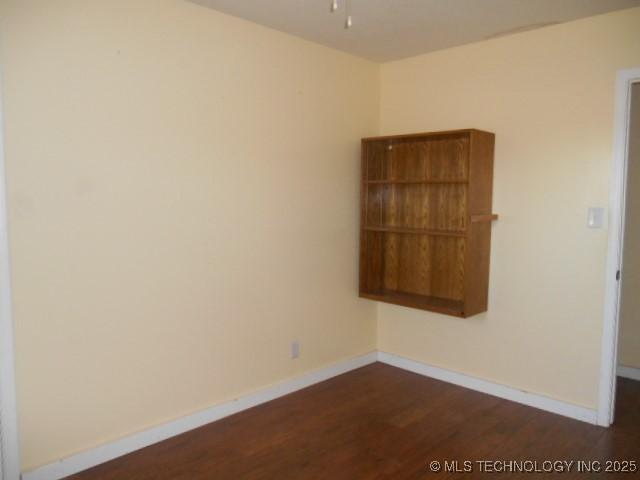 unfurnished room featuring dark hardwood / wood-style flooring