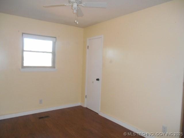 unfurnished room featuring ceiling fan and dark hardwood / wood-style floors