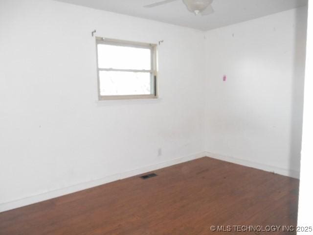 spare room with wood-type flooring and ceiling fan