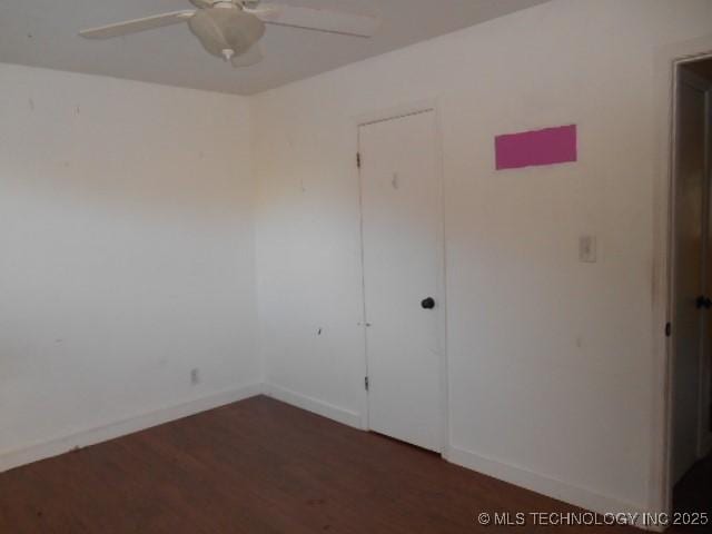 empty room featuring dark hardwood / wood-style floors and ceiling fan