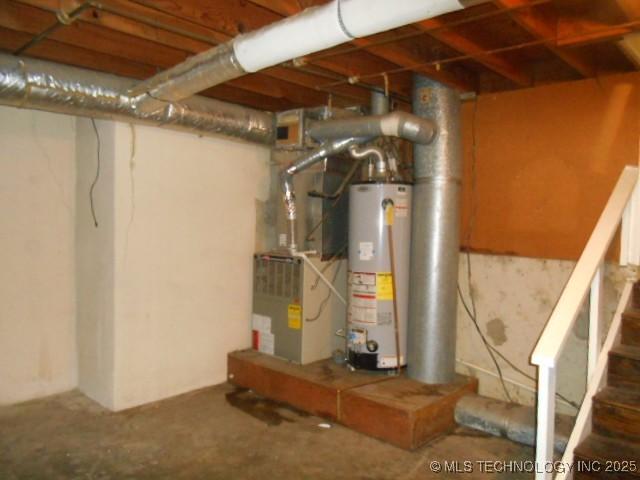 utility room with heating unit and gas water heater