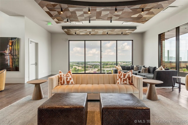 living room featuring a wealth of natural light and hardwood / wood-style floors