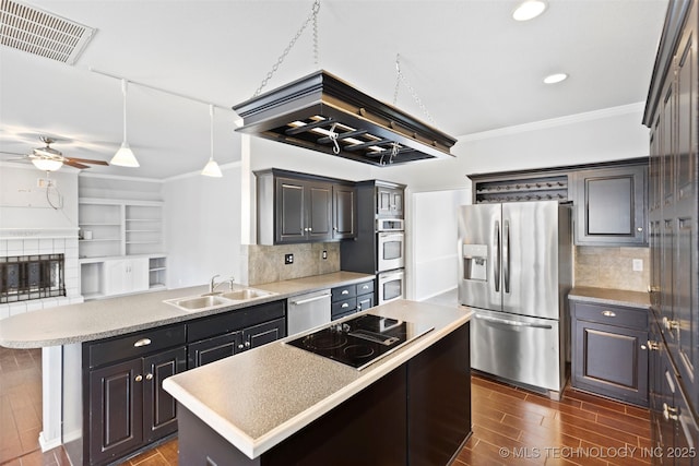 kitchen with backsplash, a center island, sink, and appliances with stainless steel finishes