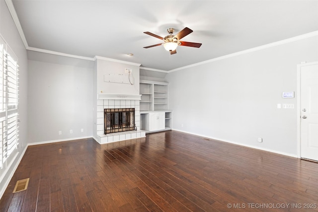 unfurnished living room with a tile fireplace, ceiling fan, dark wood-type flooring, and ornamental molding