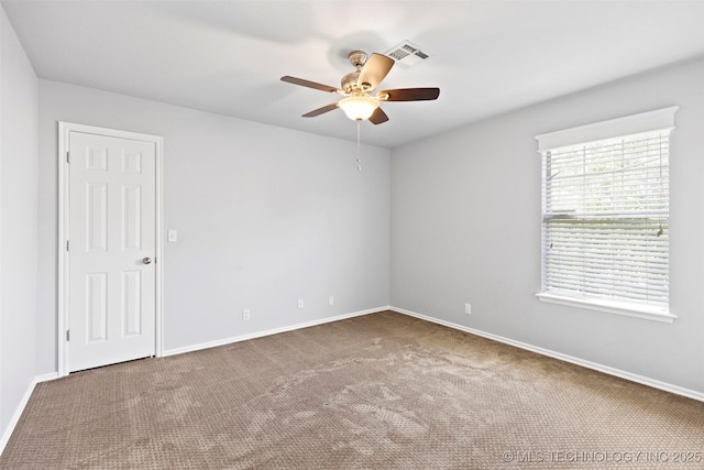 carpeted spare room with ceiling fan