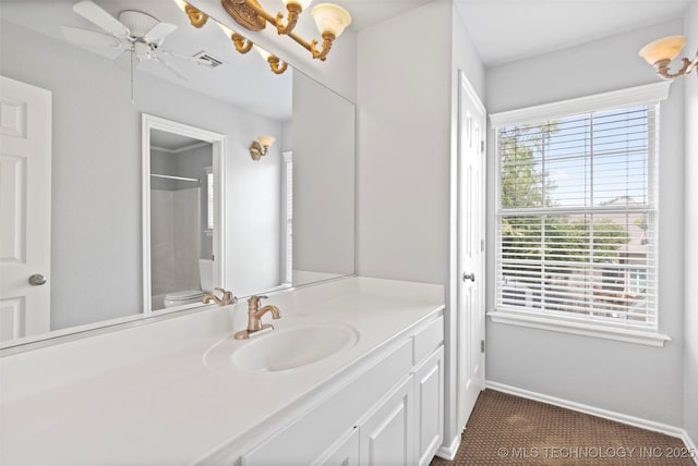 bathroom featuring vanity, ceiling fan with notable chandelier, toilet, and walk in shower