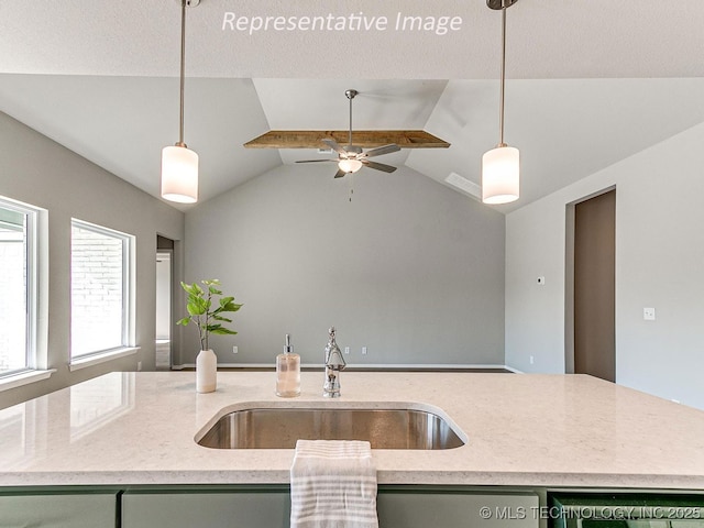 kitchen featuring a kitchen island with sink, hanging light fixtures, and lofted ceiling