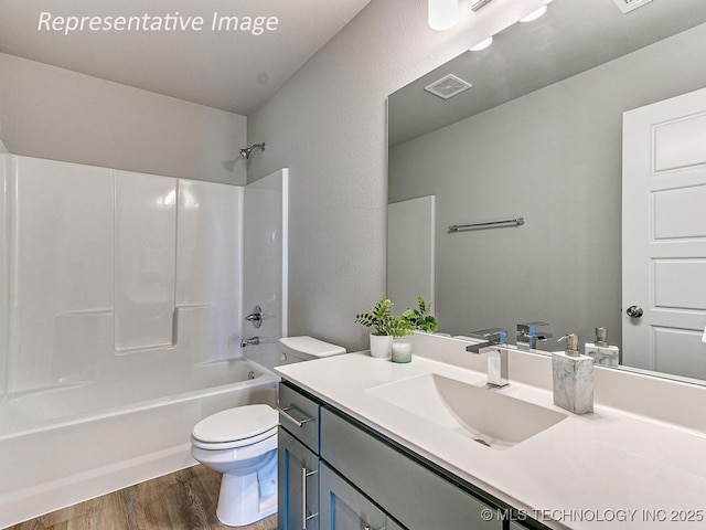 full bathroom with vanity, shower / bathing tub combination, wood-type flooring, and toilet