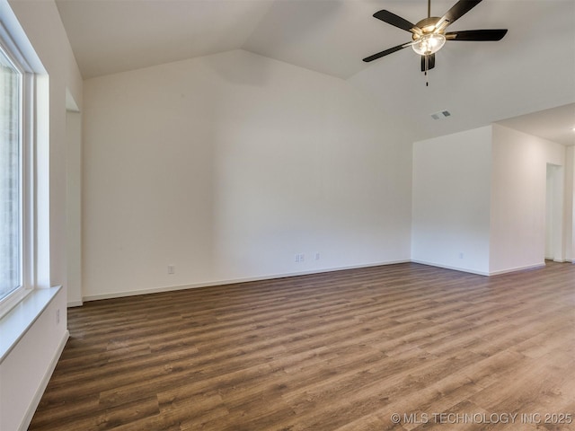 unfurnished room featuring visible vents, wood finished floors, baseboards, lofted ceiling, and ceiling fan