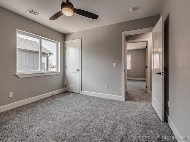 unfurnished bedroom featuring ceiling fan and carpet