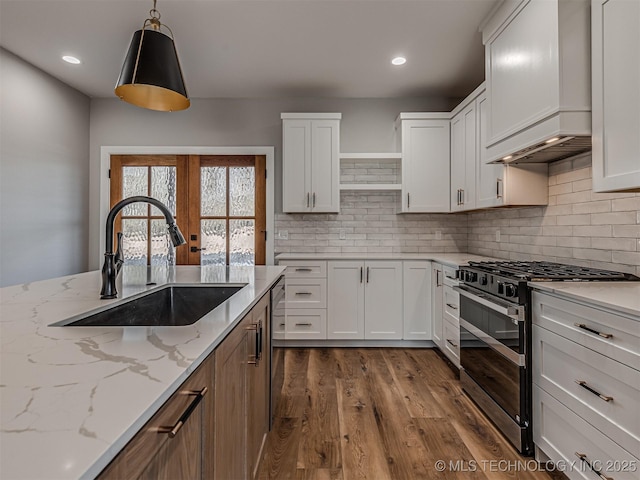 kitchen featuring stainless steel appliances, sink, and white cabinets