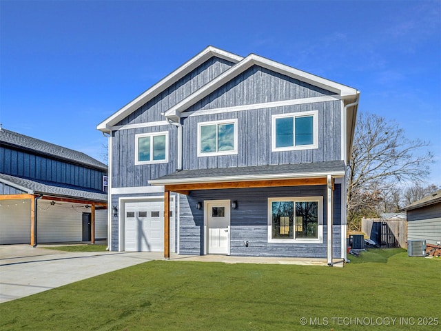 view of front of property with central AC unit, a garage, and a front yard