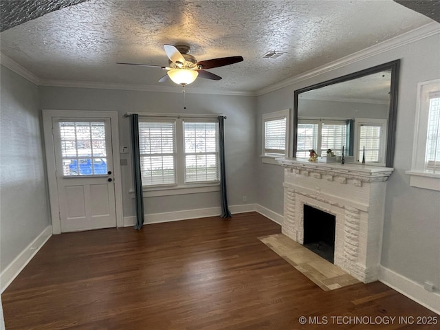 unfurnished living room with ceiling fan, dark wood-type flooring, a textured ceiling, and a brick fireplace