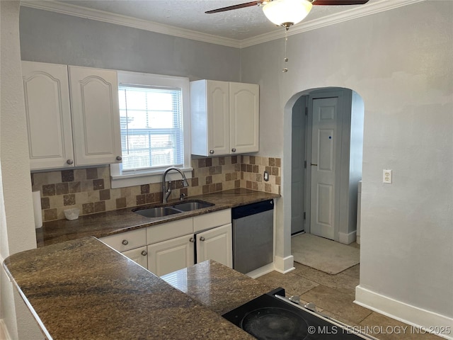 kitchen featuring decorative backsplash, white cabinetry, and sink