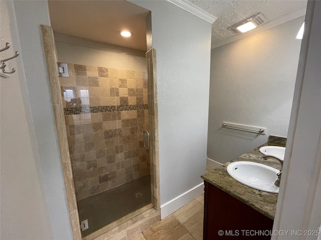 bathroom with vanity, an enclosed shower, and crown molding